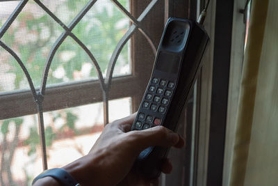 Midsection of man using mobile phone