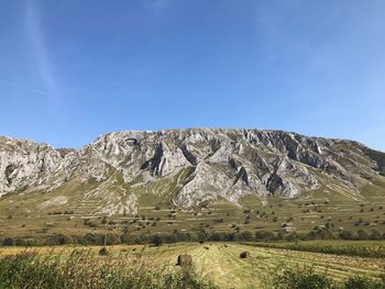 Scenic view of mountain against blue sky