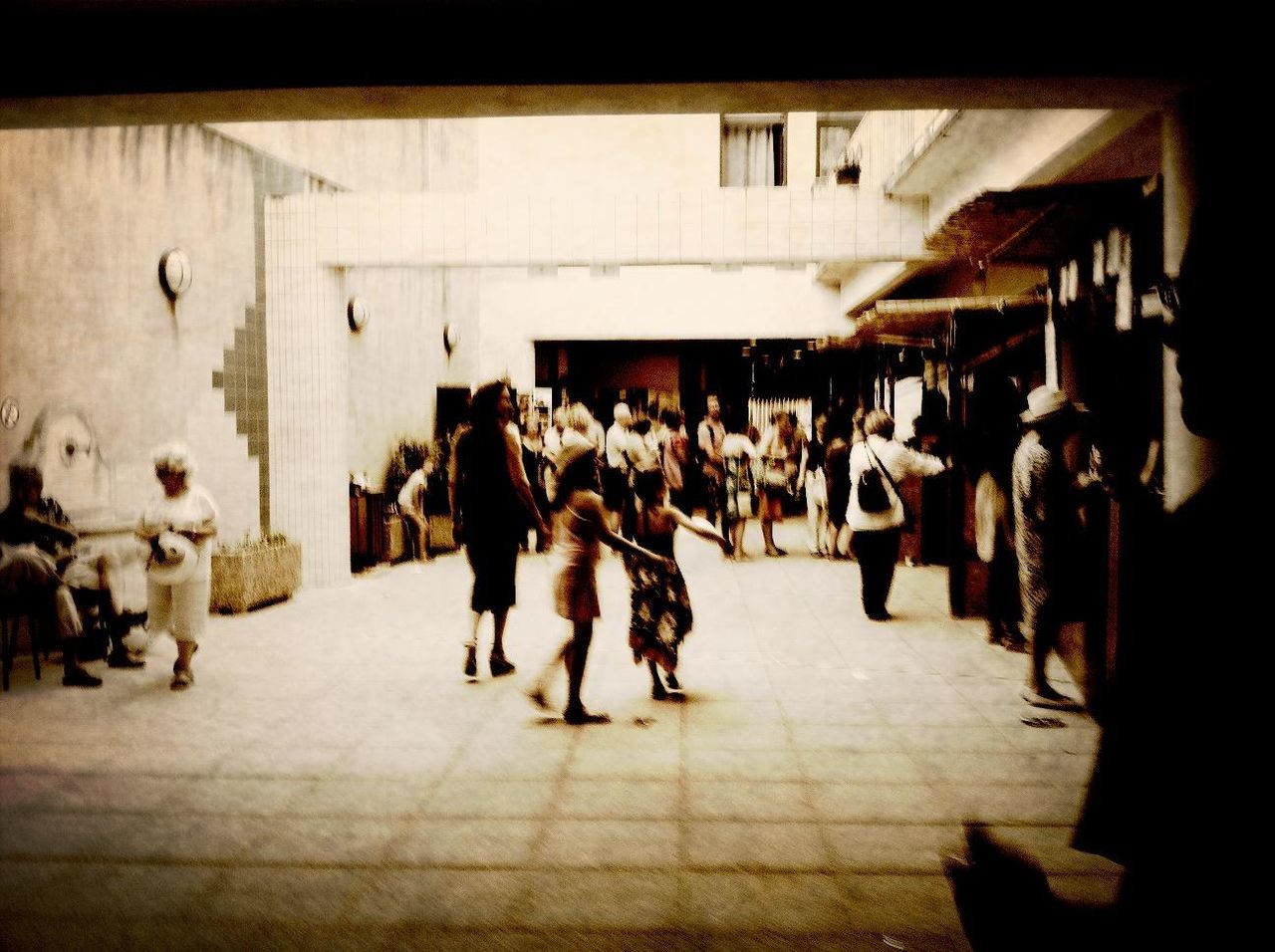 large group of people, architecture, men, person, built structure, walking, building exterior, lifestyles, city life, mixed age range, city, street, leisure activity, group of people, crowd, full length, the way forward, indoors, market