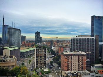 Buildings against cloudy sky