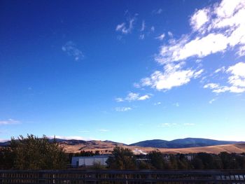 Mountain range against blue sky and clouds