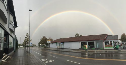 View of rainbow over buildings in city
