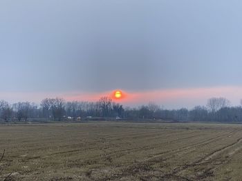 Scenic view of field against sky during sunset