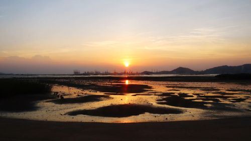Scenic view of beach against sky during sunset