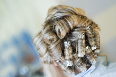 Close-up of woman wearing hair curlers