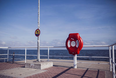 Flag by sea against sky