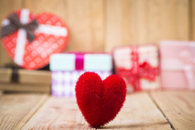 Close-up of heart shape decoration and gift boxes on table