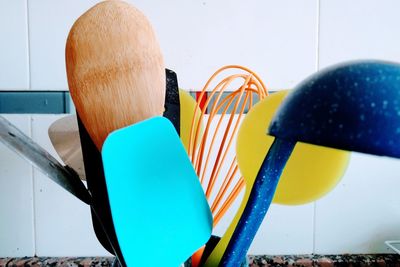 Close-up of multi colored chairs on table