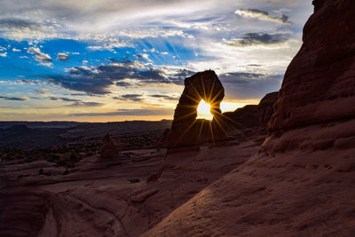 Scenic view of rock formation against sky during sunset