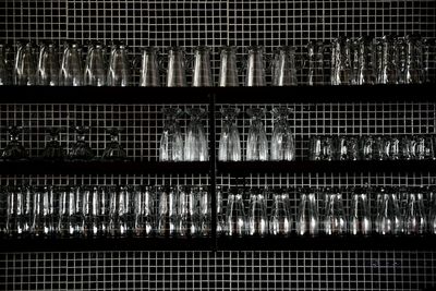 Close-up of glass arranged on shelf