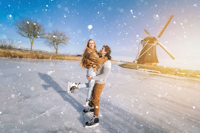 Woman with umbrella on snow during winter