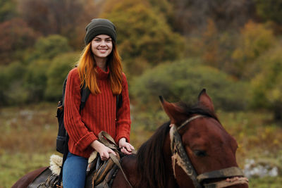 Young woman riding horse