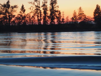 Scenic view of lake against sky during sunset