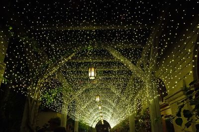 Low angle view of illuminated lights hanging at night