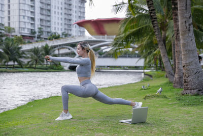 Low section of woman exercising in park