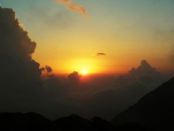 Scenic view of silhouette mountains against sky during sunset