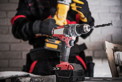 Midsection of man working at workshop