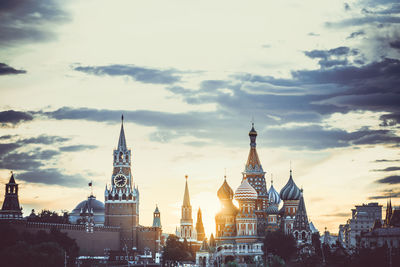 Buildings in city against cloudy sky