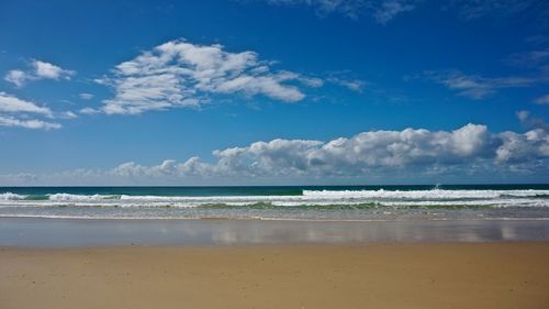 Scenic view of sea against blue sky