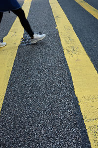 Low section of person standing on road