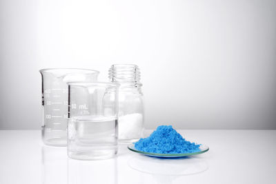 Close-up of wine glass on table against white background