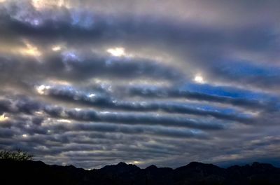Low angle view of silhouette mountains against sky