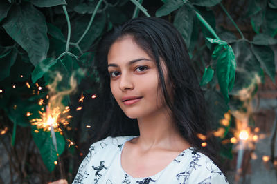 Portrait of young woman standing outdoors