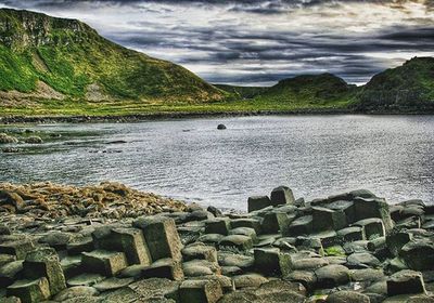 Scenic view of lake against cloudy sky