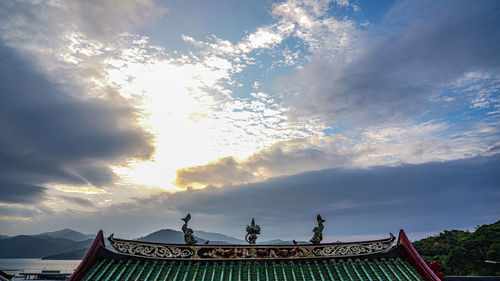Low angle view of traditional building against sky during sunset