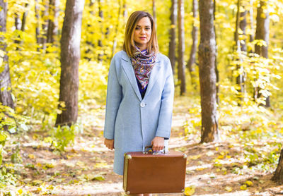 Portrait of woman standing in forest