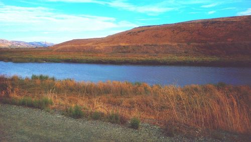 Scenic view of landscape against cloudy sky