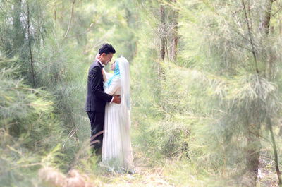 Young couple standing in forest