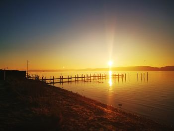 Scenic view of sea against clear sky during sunset