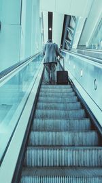 Low angle view of people on escalator