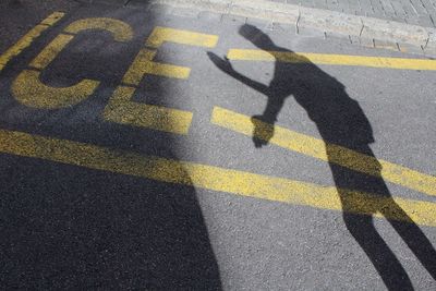 Shadow of man on road