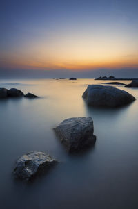 Scenic view of calm sea against cloudy sky