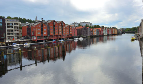 Panoramic view of river by buildings against sky