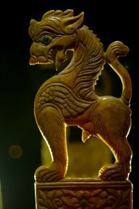 Close-up of statue against black background
