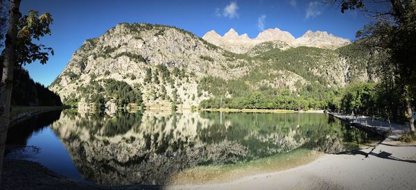 Scenic view of lake and mountains against sky