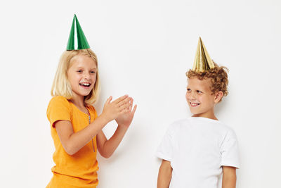 Smiling sibling against white background