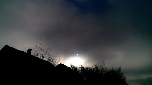 Low angle view of silhouette built structure against sky