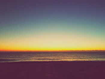 Scenic view of sea against clear sky at sunset