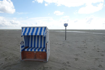 Lifeguard hut on beach against sky