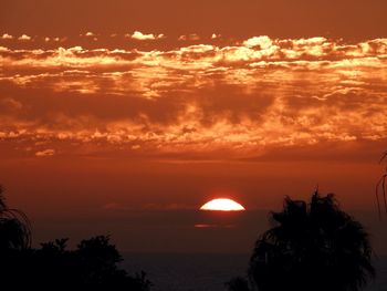 Scenic view of sea against romantic sky at sunset