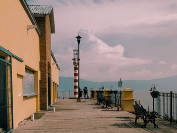 Street amidst buildings against sky