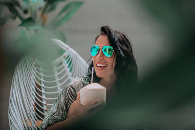 Portrait of smiling woman holding coffee cup