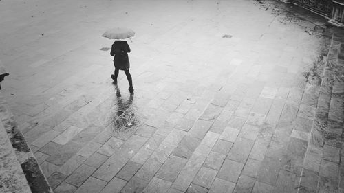 Full length of woman standing by railing