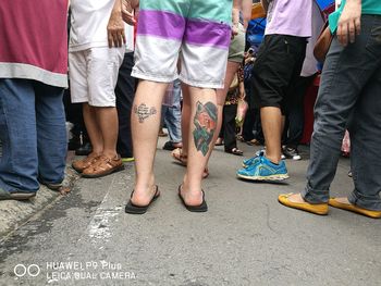 Low section of people standing on footpath