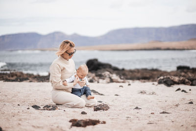 Young woman sitting on beach