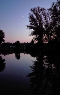 Scenic view of lake against sky at night